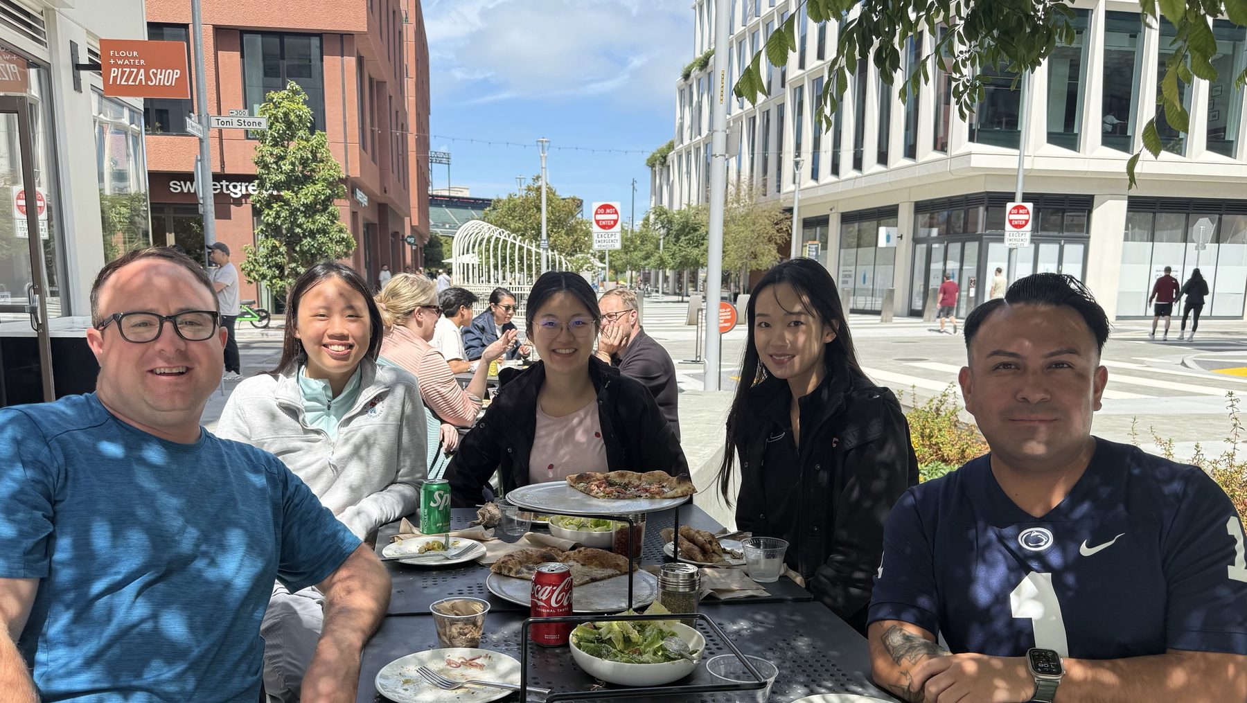 Lab members at an outdoor table with pizza in Mission Bay