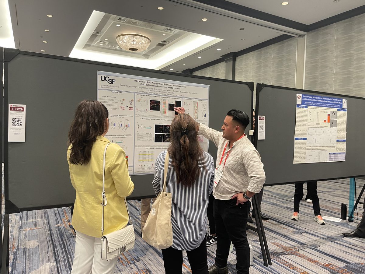 Lab member presenting a UCSF poster to visitors